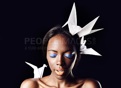 Buy stock photo Black woman, eyeshadow and fine art with beauty, dove or origami birds on a dark studio background. Closeup or face of African female person or model with blue makeup or cosmetics on mockup space