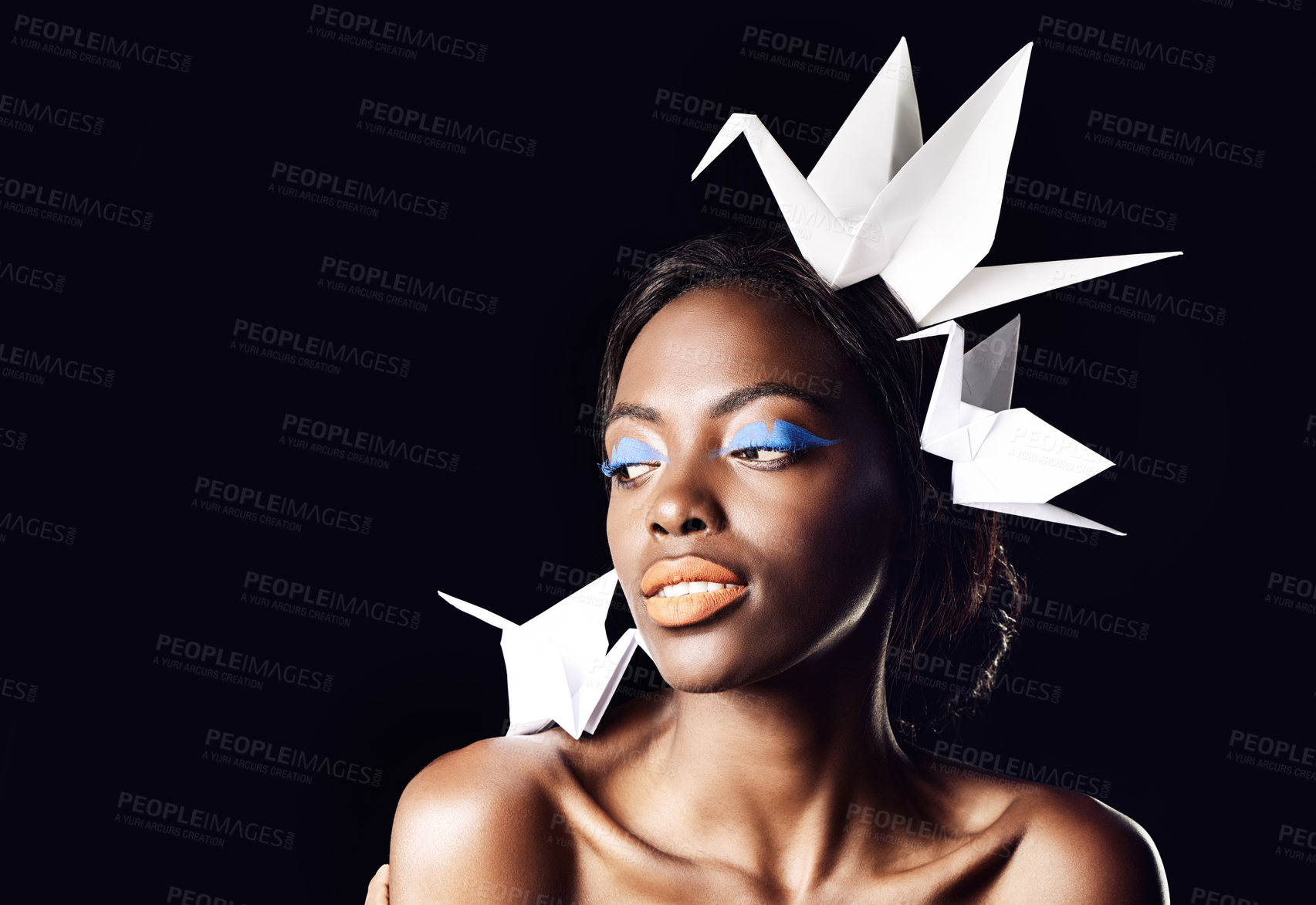 Buy stock photo Studio, makeup and natural cosmetics for black woman in dark background with aesthetic for honor. Eyeshadow, glow and foundation on face of girl for shine, African female person and origami birds
