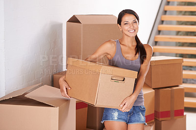 Buy stock photo Shot of a young woman moving into a new home