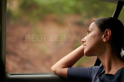 Buy stock photo A beautiful woman looking out of a car window