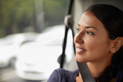 Buy stock photo A beautiful woman looking out of her window while riding in a car