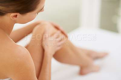 Buy stock photo Cropped shot of a young woman enjoying the feel of her skin