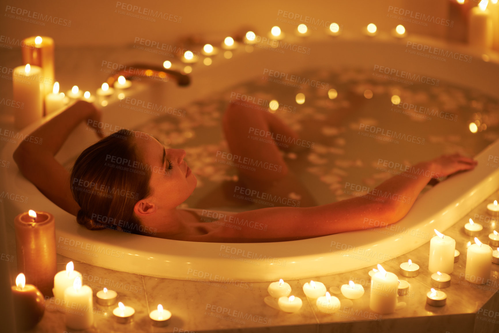 Buy stock photo Cropped shot of a gorgeous woman relaxing in a candle lit bath