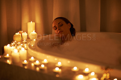 Buy stock photo Woman, bathtub and candles for relax treatment at spa or cleaning routine with bubbles for washing, hygiene or wellness. Female person, calming and stress relief skincare with peace, tub or comfort