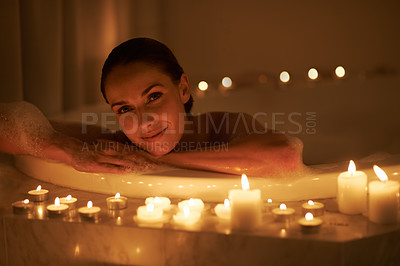 Buy stock photo Woman, portrait and bath with candles or calm cleaning routine with bubbles for treatment, hygiene or wellness. Female person, face and stress relief skincare with spa peace, self care or apartment