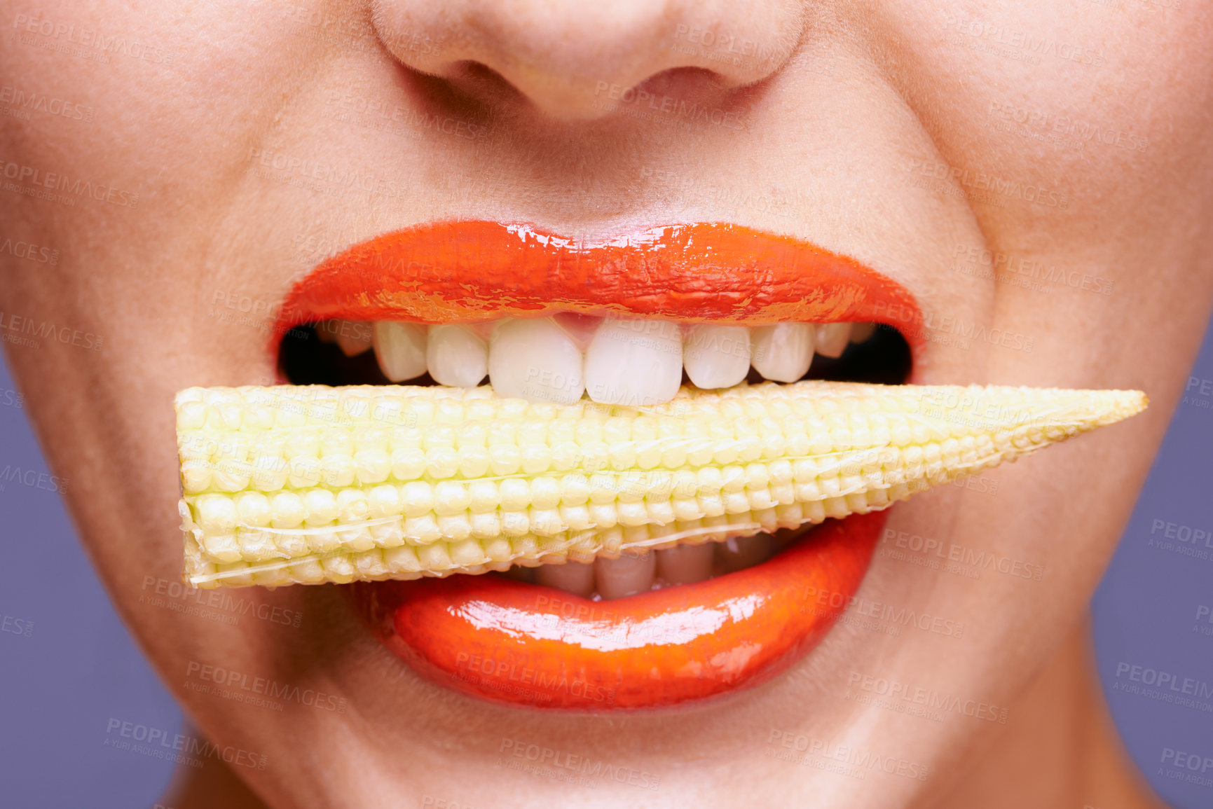Buy stock photo Woman, lipstick and vegetable in mouth for beauty, nutrition and healthy with vegan cosmetic product in studio. Cruelty free makeup, cosmetology and baby corn, orange lip gloss for aesthetic or art
