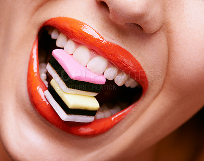 Buy stock photo Beauty, lipstick and woman with candy in mouth, makeup and creativity with closeup of shiny cosmetic product. Licorice, sweets and orange lip gloss for aesthetic, art and cosmetology with glamour