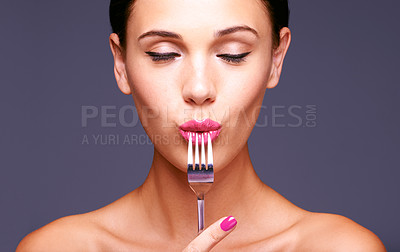 Buy stock photo Woman, studio and fork with makeup, skin and beauty for creative diet. Model, closeup and face with lipstick, lip gloss and aesthetic for glamour and health or wellness with silverware and bliss