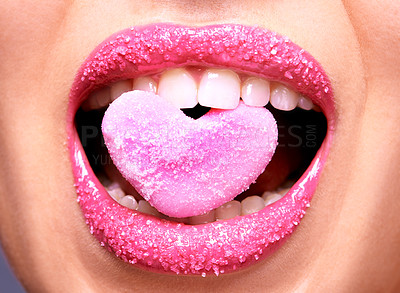 Buy stock photo Cropped shot of a woman biting on a heart shaped sweet