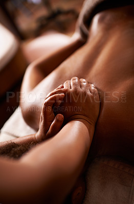 Buy stock photo Shot of a massage therapist giving a woman a massage at a day spa