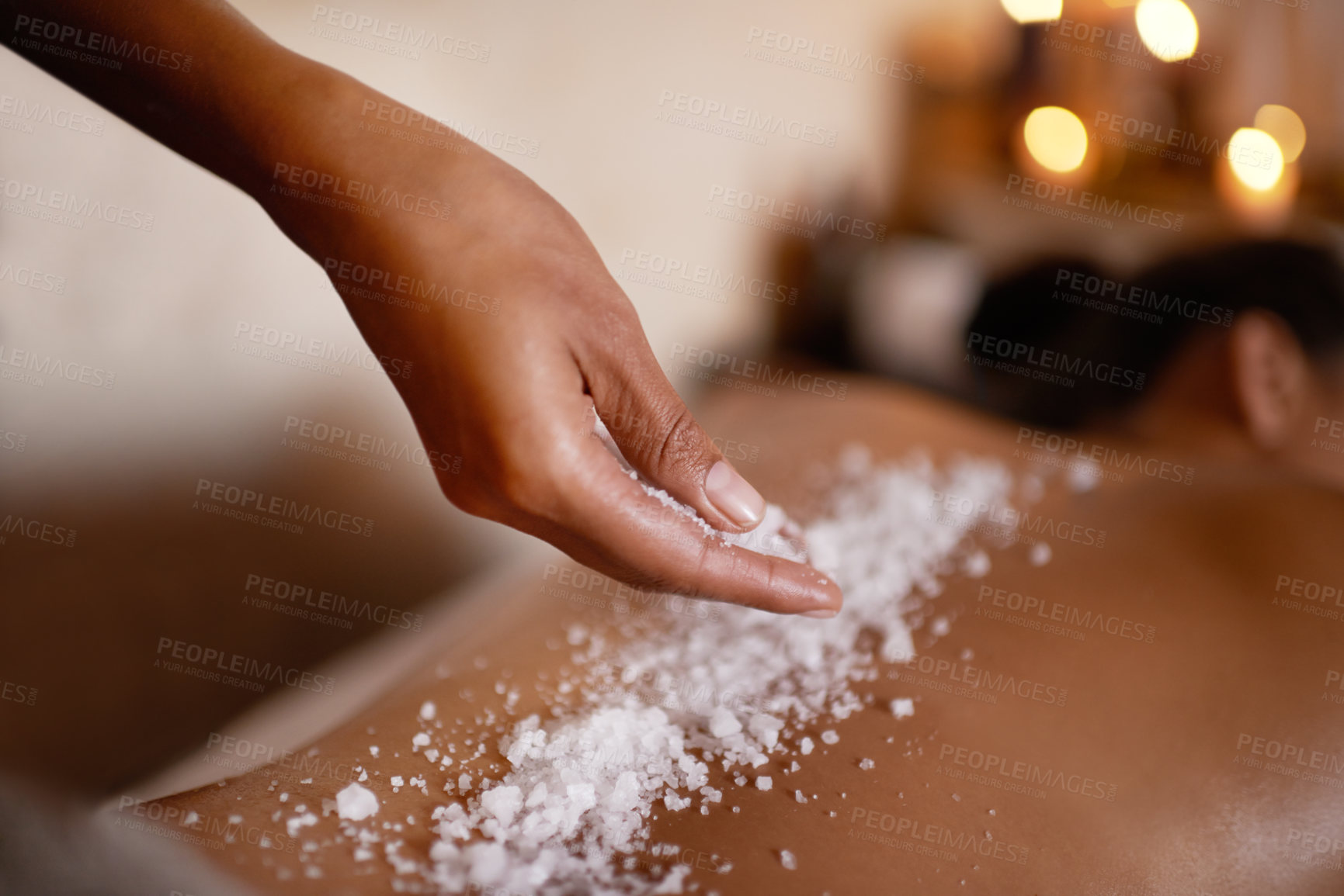 Buy stock photo Hand, massage and salt with woman at spa on bed or table for luxury pamper treatment closeup. Relax, wellness and back of customer at beauty resort or salon for holistic therapy or exfoliation