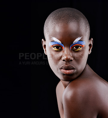 Buy stock photo Studio portrait of a beautiful model posing with colorful eye makeup on a black background