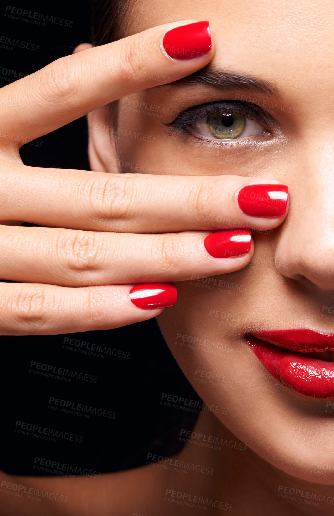 Buy stock photo Portrait, red lips and half face of woman in studio with makeup, trendy and beauty routine. Nail polish, hand and female person with facial cosmetics treatment and manicure by black background.