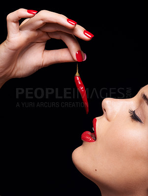 Buy stock photo Beauty, makeup and face of woman eating chilli in studio with manicure on hand isolated on a black background. Cosmetics, model and person with pepper, food or healthy organic vegetable for skincare