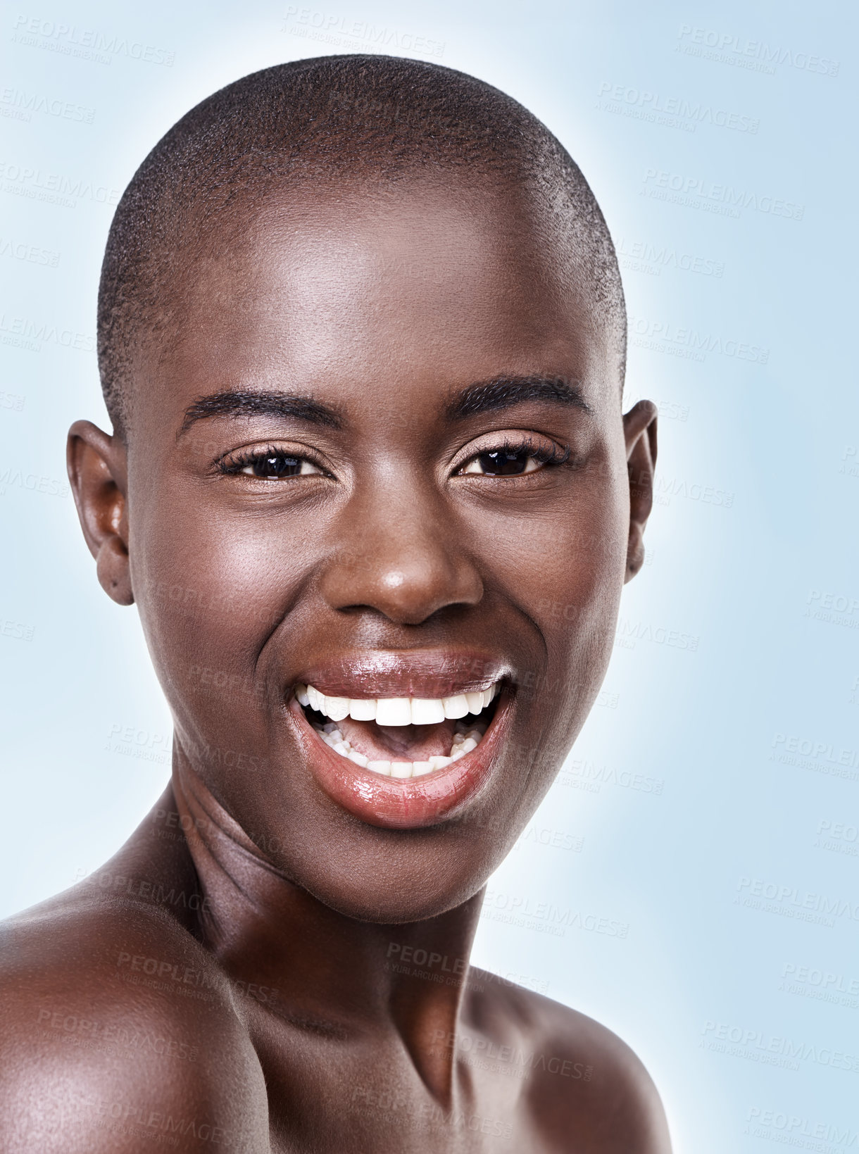 Buy stock photo Portrait, beauty and skincare with bald black woman in studio on blue background for natural wellness. Face, smile and aesthetic with happy young model at spa for cosmetics, facial or dermatology