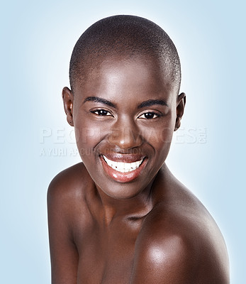 Buy stock photo Portrait, beauty and happy with bald black woman in studio on blue background for natural wellness. Face, skincare and smile with aesthetic young model at spa for cosmetics, facial or dermatology