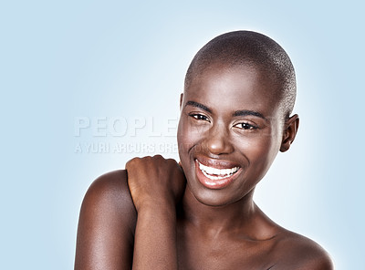 Buy stock photo Portrait, beauty and smile with bald black woman in studio on blue background for natural wellness. Face, skincare and aesthetic with happy young model at spa for cosmetics, facial or dermatology
