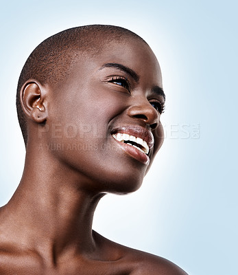 Buy stock photo Black woman, smile or thinking of beauty, skincare, natural makeup or healthy shine isolated in studio. Dermatology ideas, bald head and happy African model with glow or results on blue background