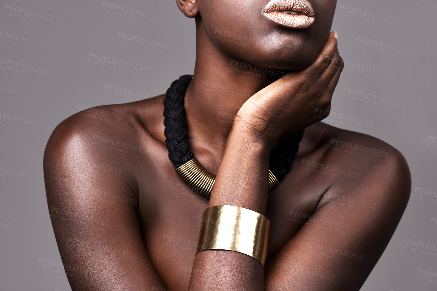 Buy stock photo Woman, fashion and jewerly with makeup in studio for aesthetic with glowing skin, lipstick and necklace. African beauty, person and cosmetics with bangle, glamour and skincare on grey background