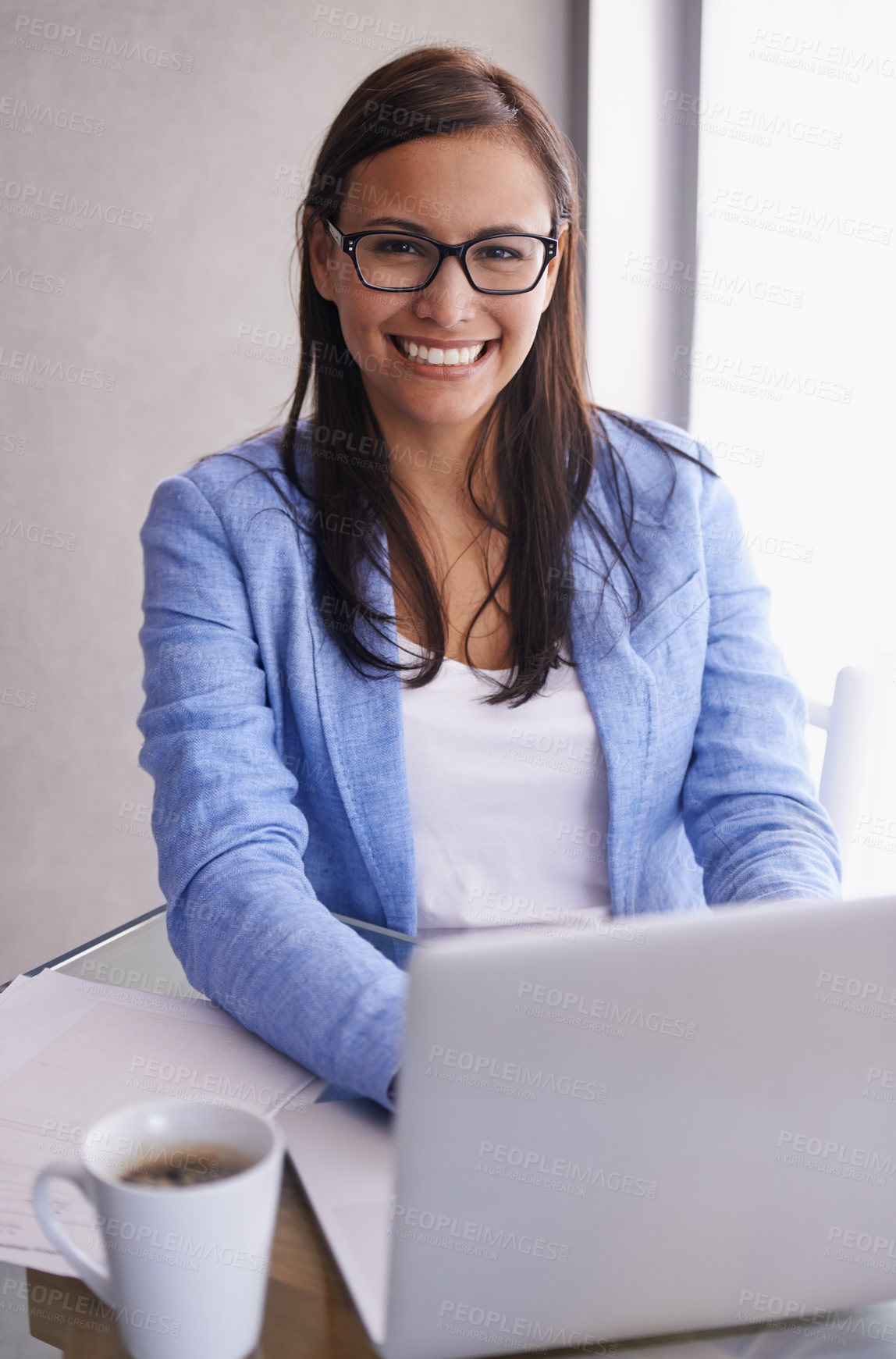 Buy stock photo Portrait of an attractive young businesswoman using a laptop at her office desk