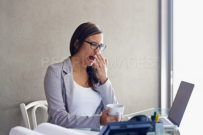 Buy stock photo An attractive young businesswoman yawning while sitting at her desk