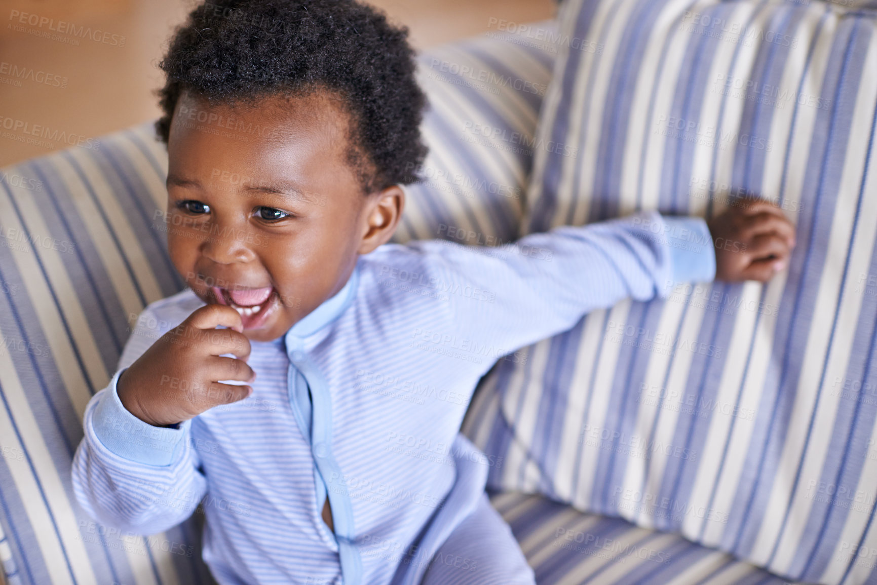 Buy stock photo Baby, smile or sofa as play, fun or game for leisure and playing, growth as relax, learn or humor. Excited, black boy child or laugh as curious confidence for motor skill coordination or development