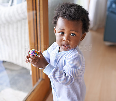 Buy stock photo Baby, portrait and ball playing in home for development growth in apartment for games, wellness or childhood. Black person, kid and face at house window in Kenya at little boy, fun, nursery or health
