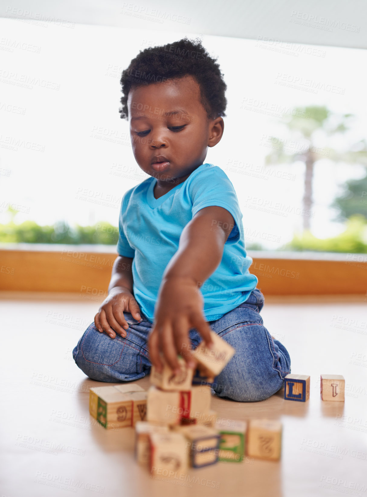 Buy stock photo Full length shot of a baby boy playing with building blocks at home