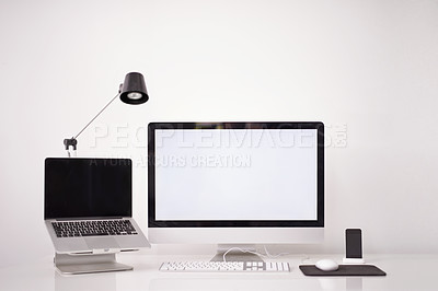 Buy stock photo Cropped shot of a handsome young man working on his laptop in an office