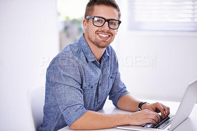 Buy stock photo A young creative businessman using his laptop