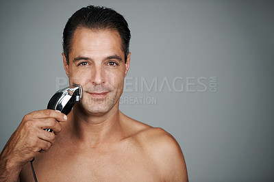 Buy stock photo Man, portrait and razor for shaving or grooming skincare for electric tool or dermatology, trimmer or grey background. Male person, face and hair removal for beard routine, mockup space or studio