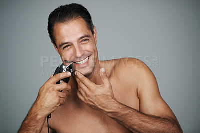 Buy stock photo Man, portrait and smile with electric razor or beard grooming in studio for skincare trimmer, self care or grey background. Male person, shave and hair removal tool or hygiene, health or mockup space