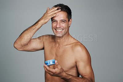 Buy stock photo Cropped portrait of a handsome mature man styling his hair with gel