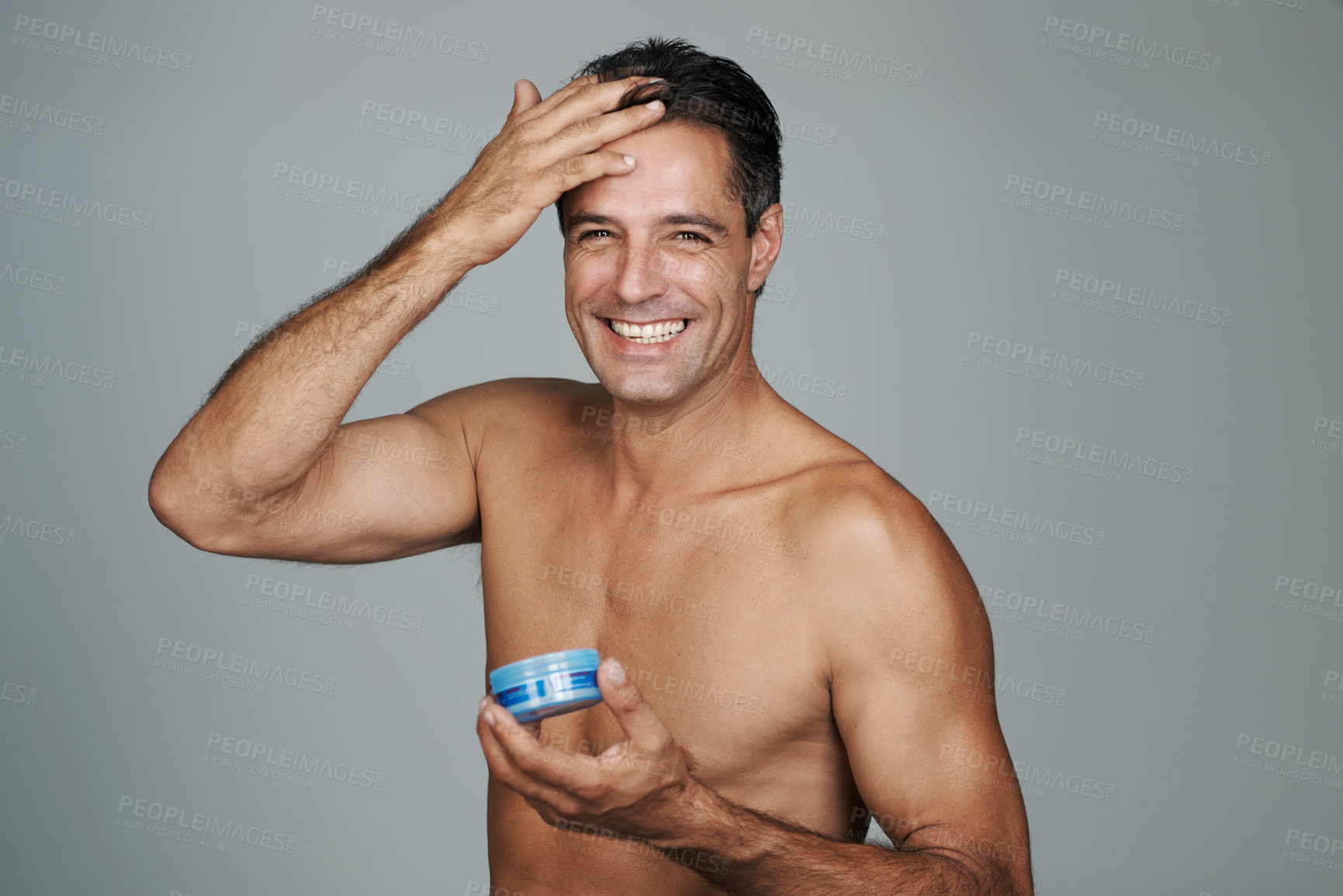 Buy stock photo Cropped portrait of a handsome mature man styling his hair with gel