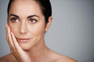 Buy stock photo Face, skincare and mature woman in makeup at studio isolated on a gray background mockup space. Cosmetics, hand and female model in touching skin for dermatology, beauty and thinking of anti aging