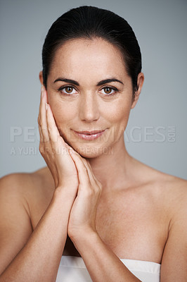 Buy stock photo Woman, studio and portrait with hands, skin and care for treatment and proud. Model, cosmetics and natural with lip gloss, glow and aesthetic for antiaging confidence isolated on grey background