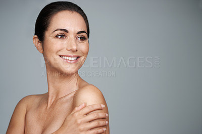 Buy stock photo Studio shot of a beautiful mature woman standing with her hand on her shoulder