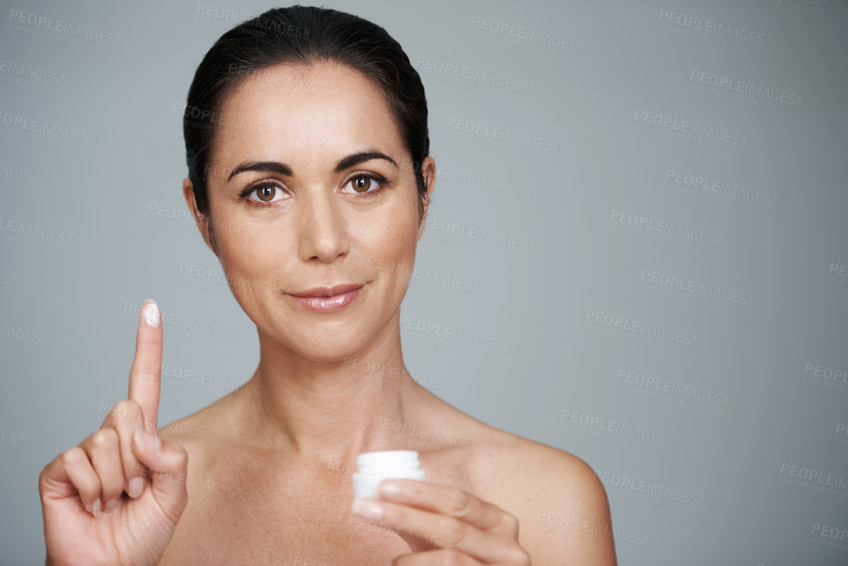 Buy stock photo Portrait, mature and woman with cream for skincare in studio isolated on gray background mockup. Face, cosmetics or model with moisturizer container for dermatology, beauty or hydration for antiaging