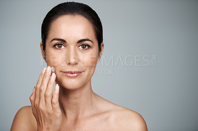 Buy stock photo Portrait, woman and face cream in studio for anti aging, skincare and cosmetics in gray background. Female person, moisturizer and daily routine or self care, confidence and skin tone in mockup space