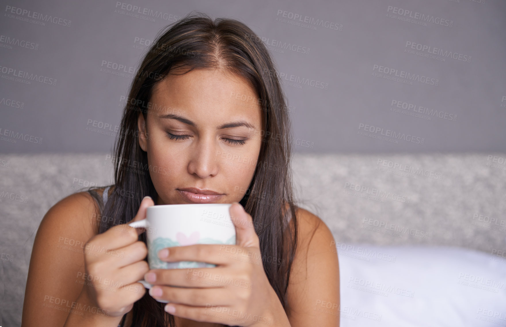 Buy stock photo Woman, eyes closed or coffee in bed to wake up in peace on morning routine as mental health. Tired, sleepy or female person for tea, warm or comfort as soothing, self care or stress relief in bedroom