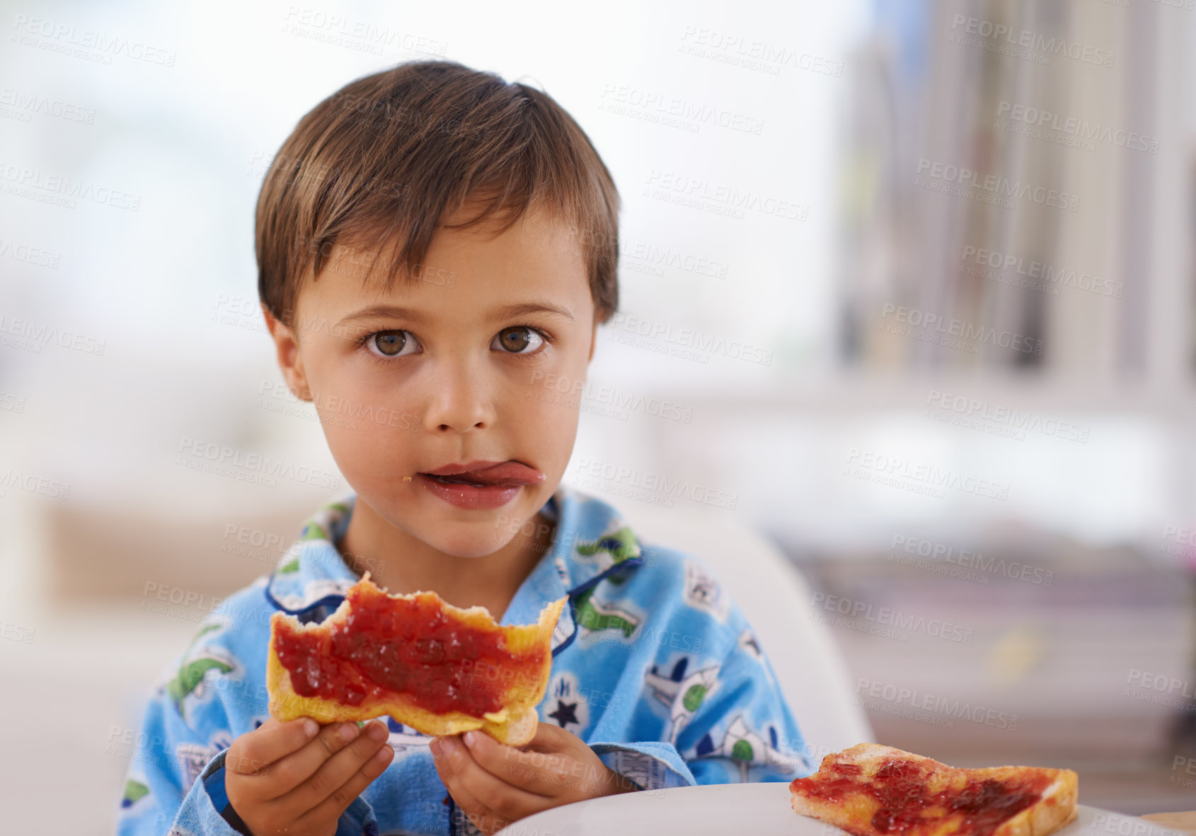 Buy stock photo Portait, food, and breakfast for young boy eating, bread and pyjamas in home for nutrition. Children, childhood and development with toast for health, jam and snack or wellness for kid male person 