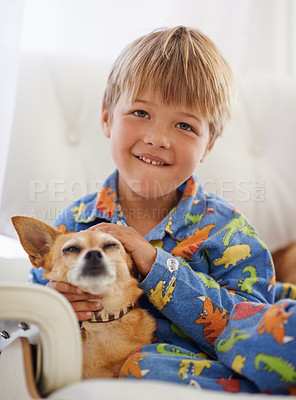Buy stock photo A cute little boy cuddling his dog on the couch