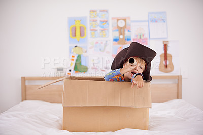 Buy stock photo Home, telescope or costume as pirate to play in boat boxes or fantasy in bedroom or house. Kid hiding, child captain or boy in an adventure game with cardboard or creative monocular to sail on ship