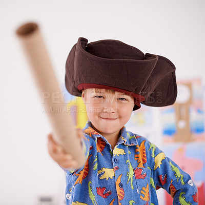 Buy stock photo Child, portrait or costume as pirate to play in fantasy in his bedroom with telescope toy or smile. Kid sailor, proud captain or happy boy in a game with pyjamas, hat or creative monocule to sail 