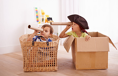 Buy stock photo Shot of two little boys pretending to be pirates in their bedroom