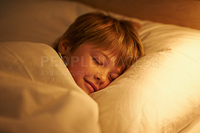 Buy stock photo Boy, bed and rest for night, sleeping and tired with fatigue and peace. Child, dreaming and exhausted with blanket, pillow and bedroom with lamp for serene childhood at home or house for childcare