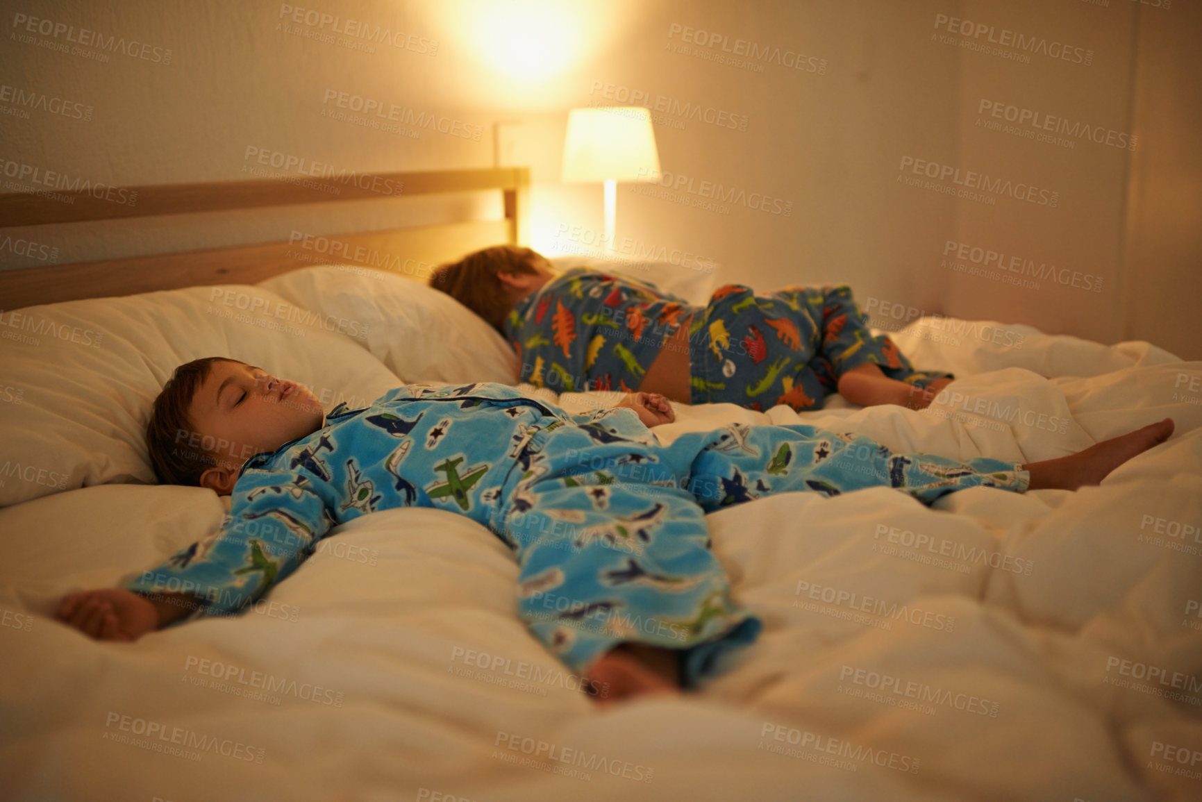 Buy stock photo Two brothers, sleeping and night in bed for rest together, peace and health in family home. Young tired kids, boy children and tired with calm sleep, fatigue and dream on blanket in bedroom at house