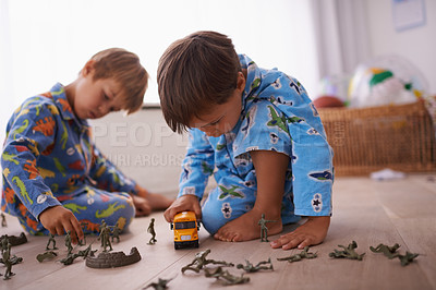 Buy stock photo Boys, playing and children in pajamas with toys for fun with action figures, car or games. Brothers, child development and young kids bonding together in playroom for learning at family home.