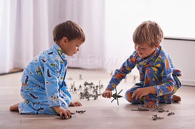 Buy stock photo Shot of two brothers playing together in their bedroom