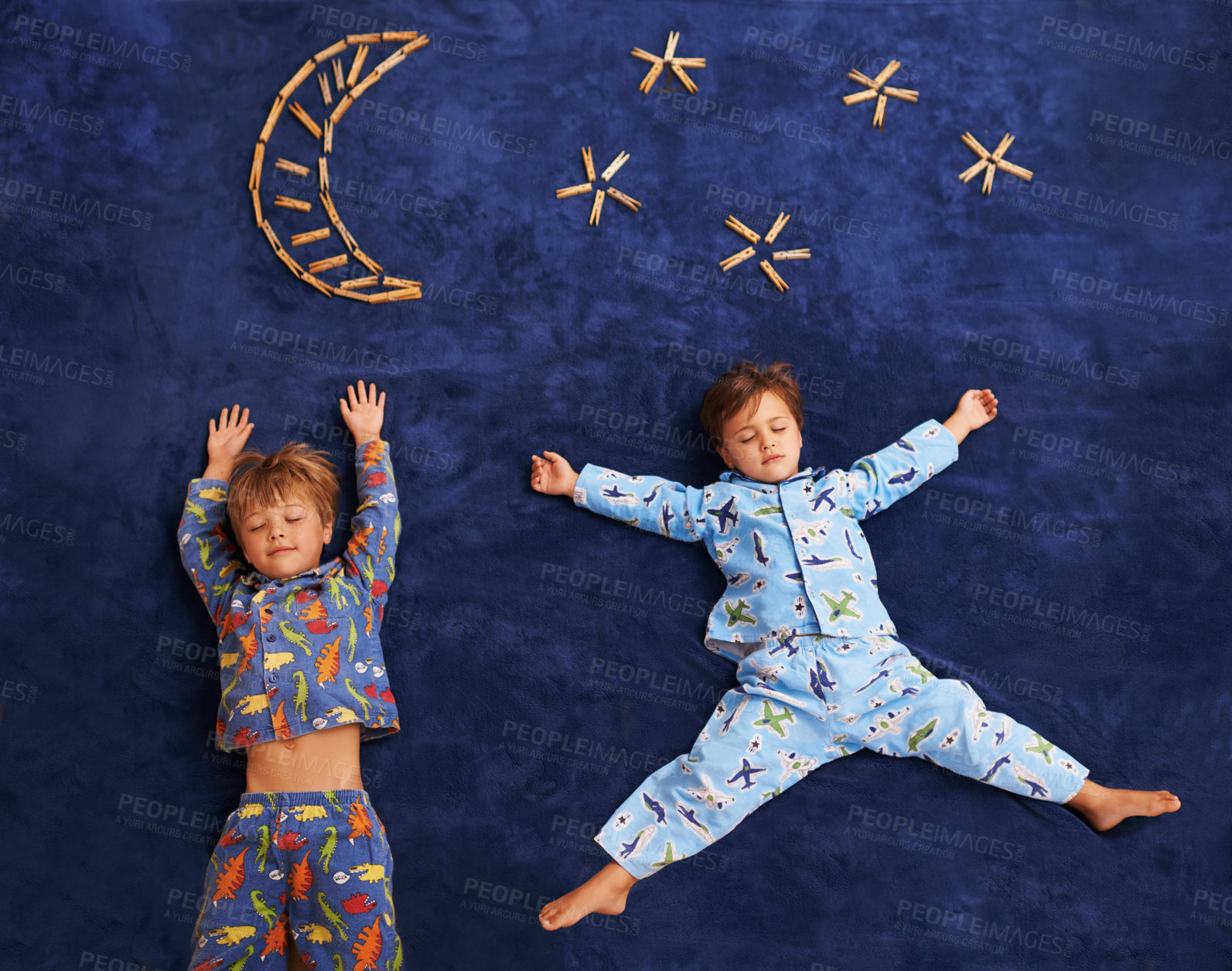 Buy stock photo Boy kids in pajamas, sleeping on carpet with moon and stars design, top view and young children dreaming. Peace, calm and tired brothers or friends sleep on galaxy art on mat at family home